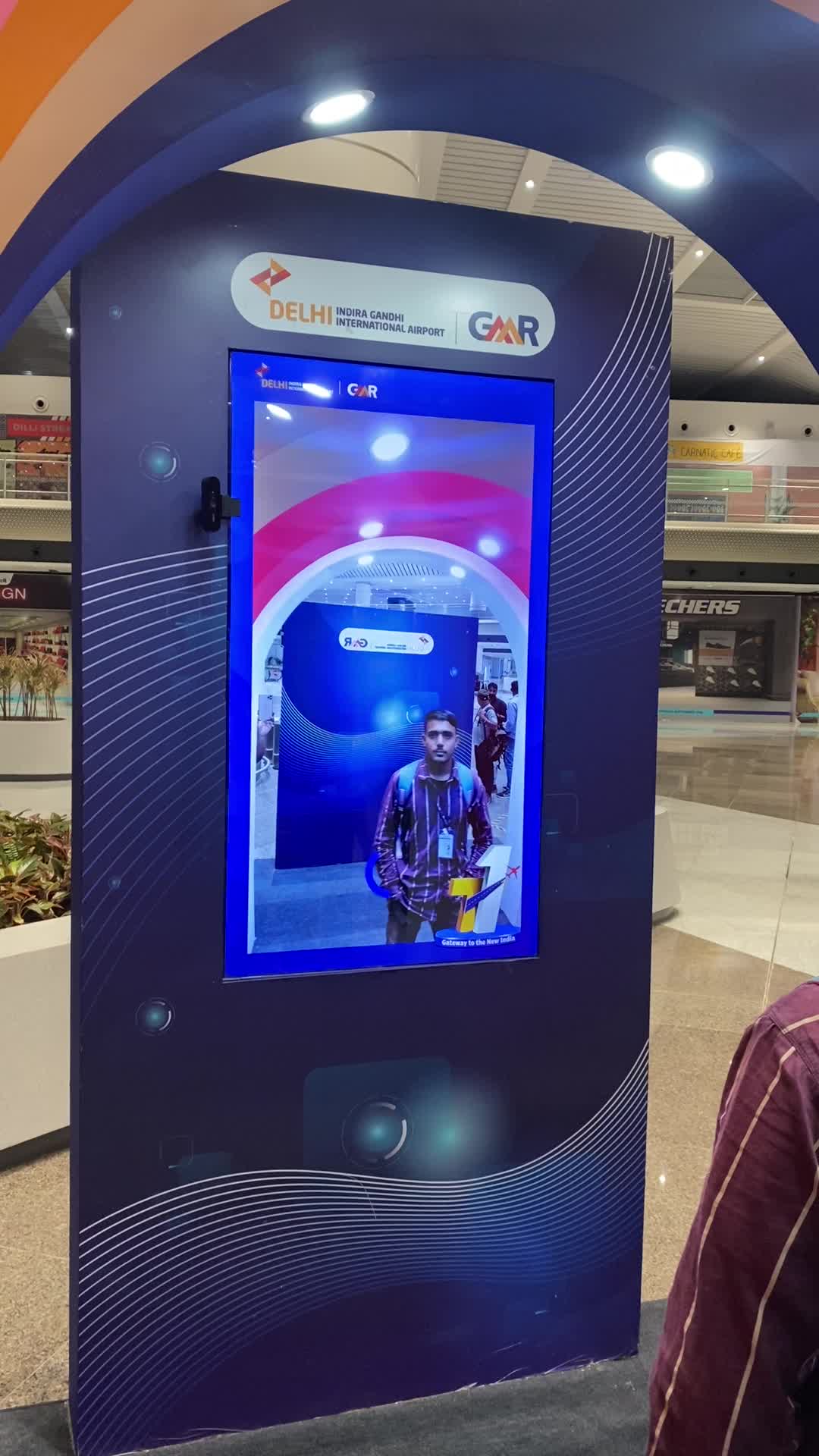 Live capture. Visitor is photographed against the kiosk's integrated lighting.